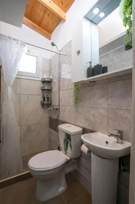 a bathroom with a toilet and a sink at Marco Beach Tiny House in Faliraki