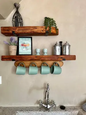 a shelf above a sink with pots and a faucet at Katrani studios in Symi