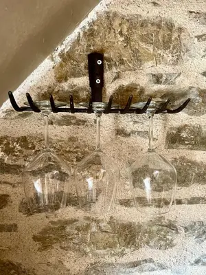two empty wine glasses hanging on a wall at Katrani studios in Symi