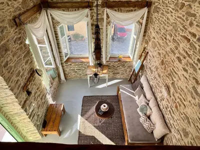 an overhead view of a living room with a couch and windows at Katrani studios in Symi