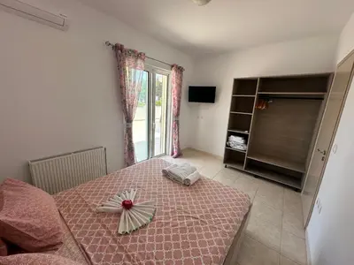 a bedroom with a bed with a flower on it at Treditto House - Ground Floor residence C1 in Koskinou