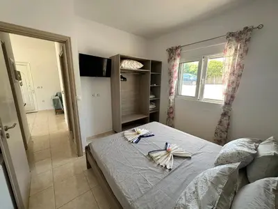 a bedroom with a bed with towels on it at Treditto House - Ground Floor residence C1 in Koskinou
