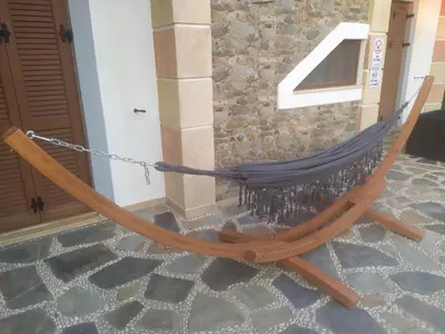 a hammock tied to the side of a building at Sun Dream Villa in Ialyssos