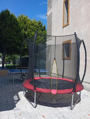 a swing in front of a building at Sun Dream Villa in Ialyssos