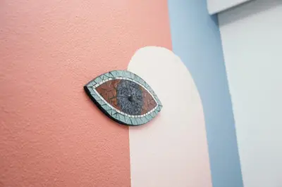 a button on the side of a pink wall at Villager's Art Apartment in Paradeísion