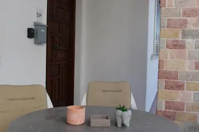 a table with two chairs and a table with a plant on it at Villager's Art Apartment in Paradeísion