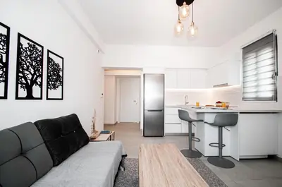 a living room with a couch and a kitchen at Anesis Town Apartments in Rhodes Town