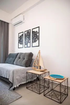 a living room with a couch and two tables at Anesis Town Apartments in Rhodes Town