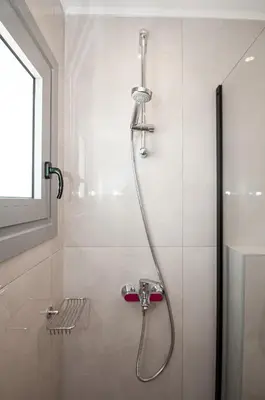 a shower with a shower head in a bathroom at Anesis Town Apartments in Rhodes Town
