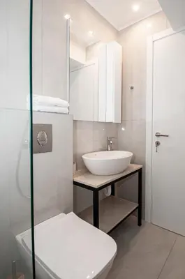 a white bathroom with a sink and a toilet at Anesis Town Apartments in Rhodes Town