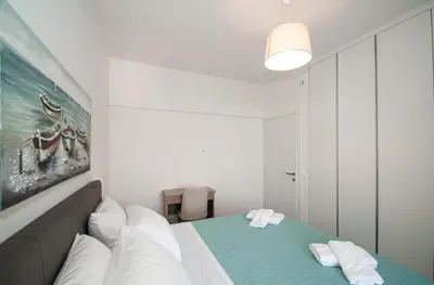 a bedroom with a bed and a couch at Anesis Town Apartments in Rhodes Town