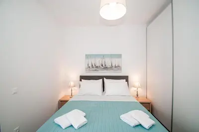 a bedroom with a bed with two towels on it at Anesis Town Apartments in Rhodes Town