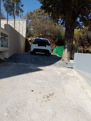 a white car parked next to a tree at Eramel Cozy Apartment with Sea View in Rhodes Town