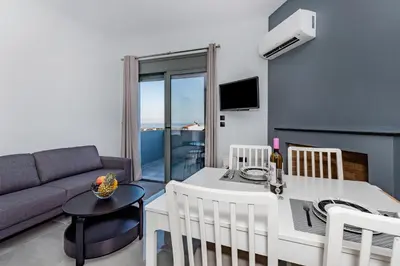 a living room with a couch and a table at Eramel Cozy Apartment with Sea View in Rhodes Town