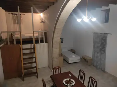 a room with a table and a room with a bed at Ioanna Residence Kattavia in Kattavía