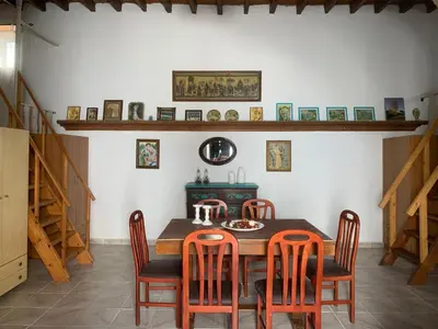 a dining room with a wooden table and chairs at Ioanna Residence Kattavia in Kattavía