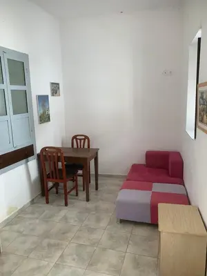 a room with a bed and a table and a couch at Ioanna Residence Kattavia in Kattavía
