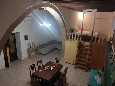 a room with a table and a bed in a room at Ioanna Residence Kattavia in Kattavía