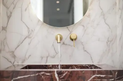 a bathroom with a marble sink and a mirror at Ocean Pearl Sea View in Faliraki