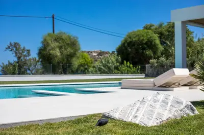 a villa with a swimming pool and a yard at Ocean Pearl Sea View in Faliraki