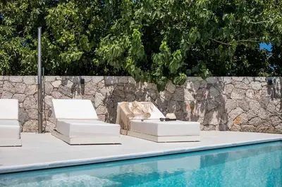two lounge chairs sitting next to a swimming pool at Ocean Pearl Sea View in Faliraki