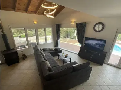 a living room with couches and a flat screen tv at villa Aphrodite Rhodes in Pastida