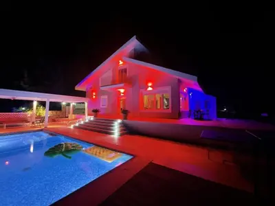 a house with a swimming pool at night at villa Aphrodite Rhodes in Pastida