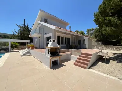 a house with a fireplace in front of it at villa Aphrodite Rhodes in Pastida