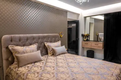 a bedroom with a large bed and a mirror at Odysseus Luxury House in Rhodes Town
