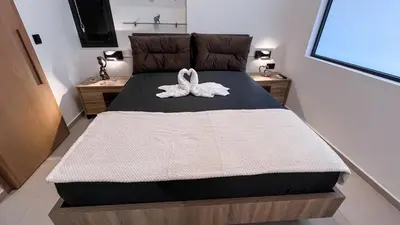 a bedroom with a bed with two swans on it at Wohlfühloase 1 Casa Elena und Gerd in Rhodes Town