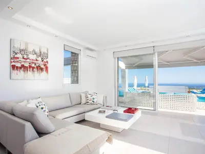 a living room with a couch and a large window at Villa in Rhodes with Infinity Pool & BBQ in Kalithies