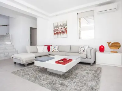 a living room with a couch and a coffee table at Villa in Rhodes with Infinity Pool & BBQ in Kalithies