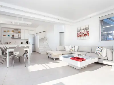 a white living room with a couch and a table at Villa in Rhodes with Infinity Pool & BBQ in Kalithies