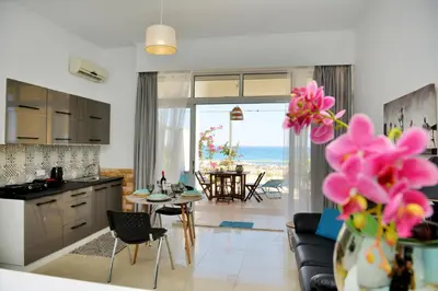 a kitchen and living room with a view of the ocean at Studio Mare Faliraki in Faliraki