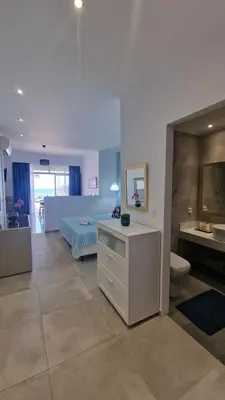 a bedroom with a bed and a bathroom at Studio Mare Faliraki in Faliraki