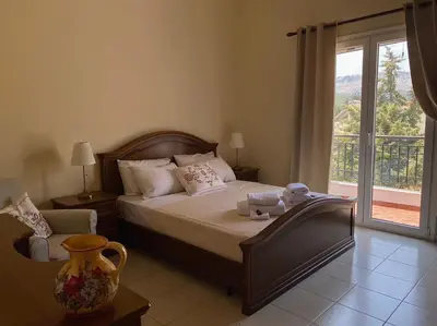 a bedroom with a bed and a large window at Villa Sofia with garden, pool and lounge areas in Kolimbia