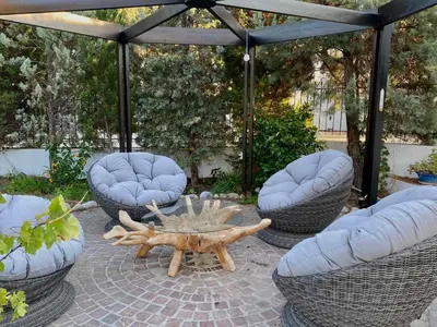 a patio with a table and two chairs and a tent at Villa Sofia with garden, pool and lounge areas in Kolimbia