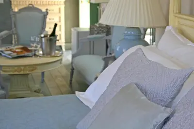 a bedroom with a bed and a table with a lamp at The Old Markets in Symi