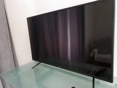 a flat screen tv sitting on top of a glass table at Yiannis Sokaki detached House in Rhodes Town