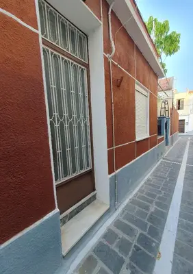 a building with a gate on the side of a street at Yiannis Sokaki detached House in Rhodes Town