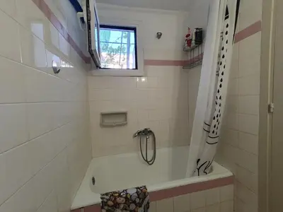 a bathroom with a tub and a window at Yiannis Sokaki detached House in Rhodes Town