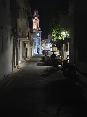a city street with a clock tower at night at Yiannis Sokaki detached House in Rhodes Town