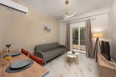 a living room with a couch a table and a tv at Casa di Calma & Casa di Luce Rhodes Apartments in Rhodes Town