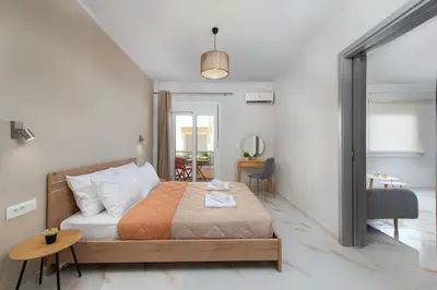a bedroom with a bed and a table and a desk at Casa di Calma & Casa di Luce Rhodes Apartments in Rhodes Town