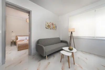 a living room with a couch and a table at Casa di Calma & Casa di Luce Rhodes Apartments in Rhodes Town