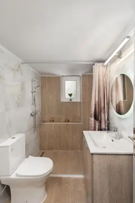 a bathroom with a toilet and a sink and a mirror at Casa di Calma & Casa di Luce Rhodes Apartments in Rhodes Town