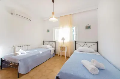 a bedroom with two beds with towels on them at Villa Dora in Faliraki