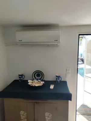 a kitchen with a blue counter top and a stove at Platanos Villa in Haraki