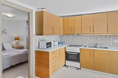 a kitchen with a sink and a stove top oven at Platanos Villa in Haraki