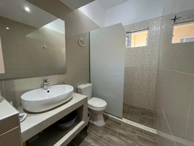a bathroom with a sink and a toilet and a shower at Nesèa Apartment Faliraki in Faliraki